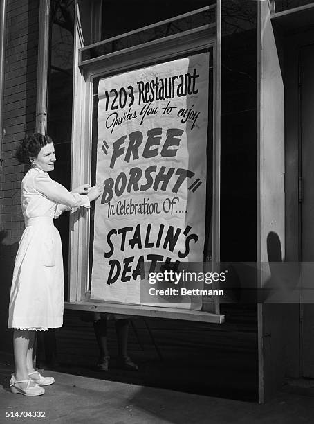 Washington, DC: Eileen Keenan, a waitress at the 1203 Restaurant, puts up a sign outside the restaurant, March 6, inviting everyone to enjoy "Free...