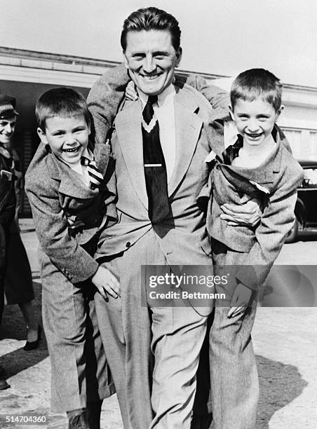 Paris, France: Obviously happy to see his two sons is film actor Kirk Douglas, who gives the boys a hearty welcome at Orly Airport after their...