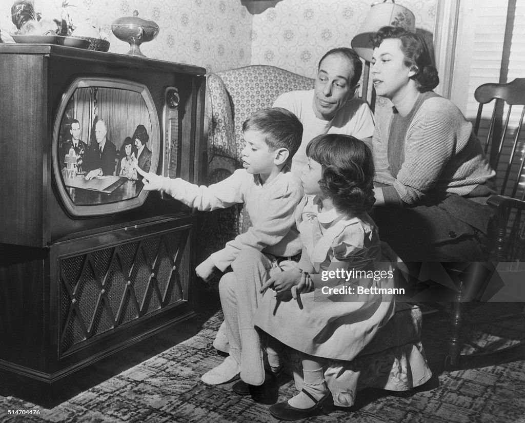 Family Watches Daughter on Television