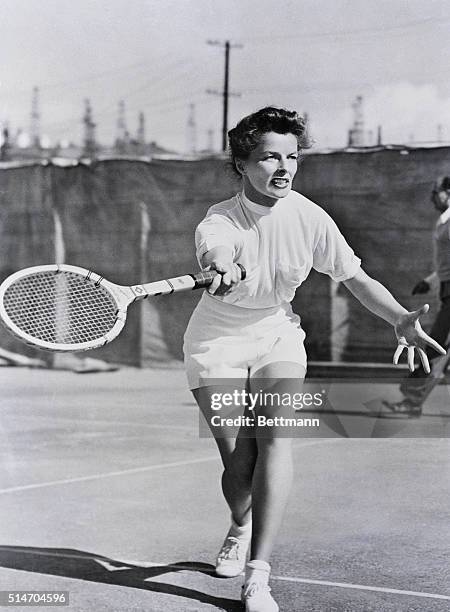 Hollywood, California: Screen star Katharine Hepburn gets out in tennis togs for a few volleys, and her good looks on the court to be competition for...