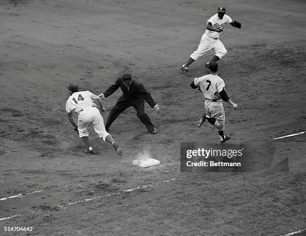 New York, NY: Mickey Mantle, Yankees, beats out a bunt in the fourth inning of the last game of the World Series played at Ebbets Field. Gil Hodges...
