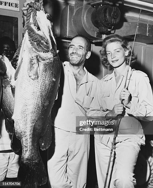 Africa: "On the left is an 80-pound perch caught in Lake Albert in British Yganda. In the center, proud, happy and beaming over the catch, is me. On...