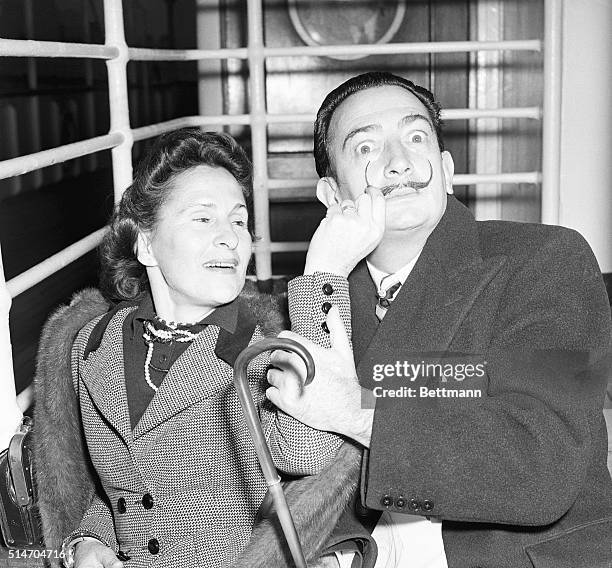 New York: Salvador Dali, surrealist painter, and his wife, Gala, arrive in New York, Dec. 24, aboard the Liner America. Dali, whose newly-regrown...
