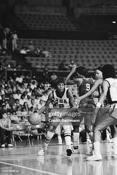 American Cheryl Miller dribbles the ball and looks toward teammate Lynette Woodard in a basketball game against the Cuban team in the 1983...