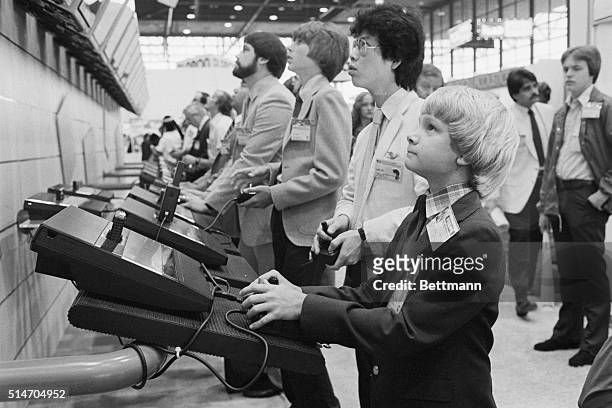 Eleven year old Rawson Stovall plays the latest video games at the 1983 Consumer Electronics Show as research for his video games newspaper column.