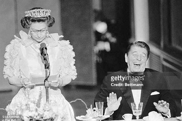 President Reagan laughs following a joke by Queen Elizabeth II, who commented on the lousy California weather she has experienced since her arrival...