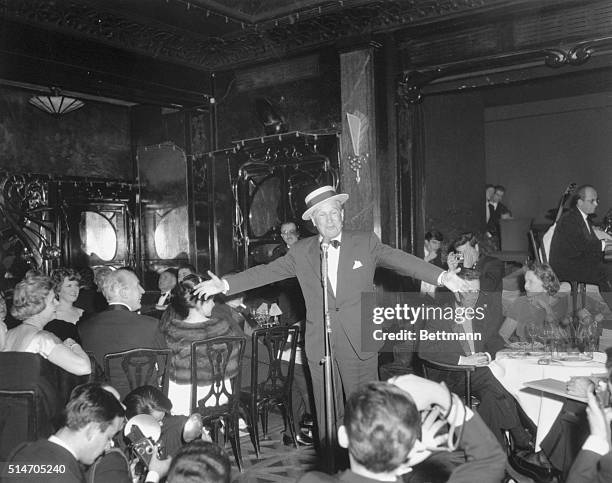 Paris, France: Famed French entertainer Maurice Chevalier sings in Maxim's restaurant here, Feb. 13th, during a supper following a gala performance...