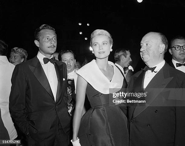 To r: Alfred Hitchcock, Grace Kelly and Oleg Cassini at the premiere of "Rear Window."