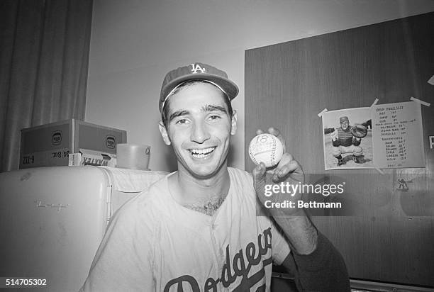 Los Angeles, CA: Dodger pitcher Sandy Koufax holds the ball that tells the story. Koufax strcuk out 18 Giants as he equaled a Major League strikeout...