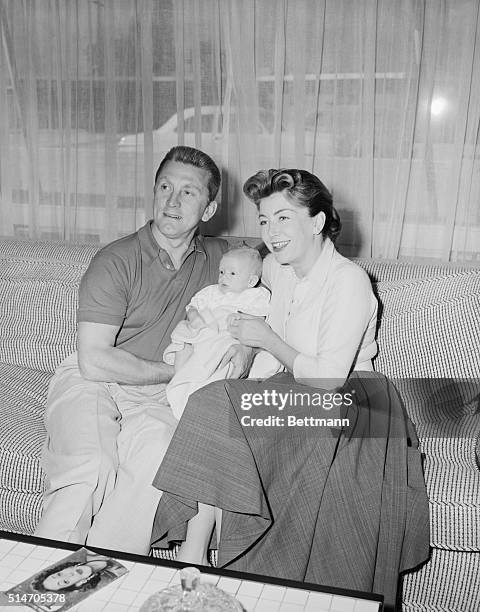 Palm Springs, CA: Film star Kirk Douglas and wife Anne, former French publicist, proudly show off their son Peter Vincent, two months, while...