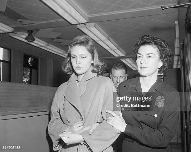 Beverly Hills, California: Cheryl Crane , daughter of Steve Crane and actress Lana Turner, is escorted from the jail here to juvenile hall in Los...