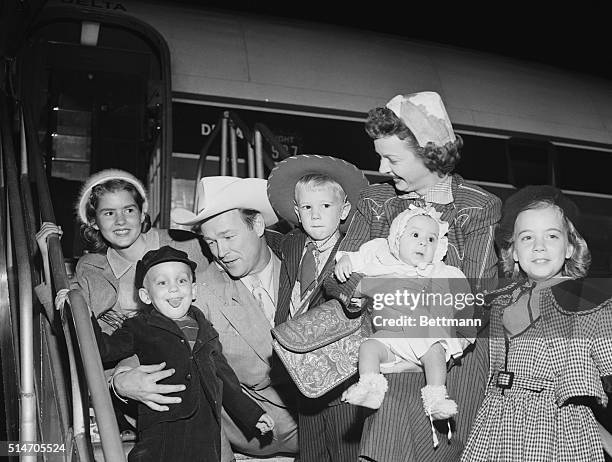 Los Angeles: Cowboy-Actor Roy Rogers and actress wife Dale Evans arrive by plane in Los Angeles, Bringing with them two newly adopted children, five...