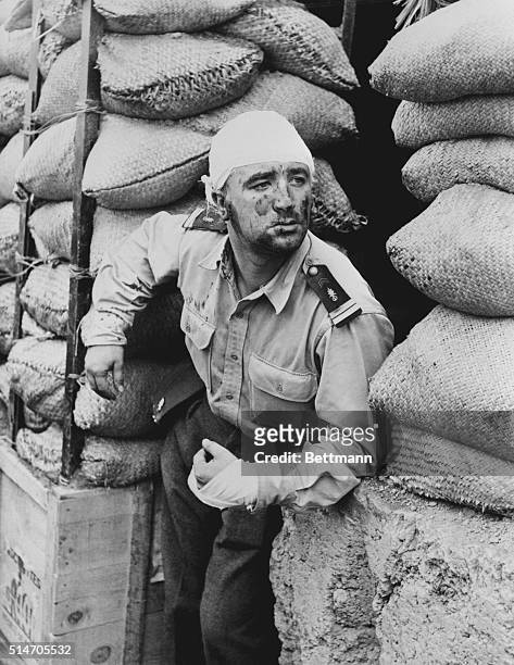 Dien Bien Phu, Korea: Foreign Legion lieutenant standing between stacks of goods.