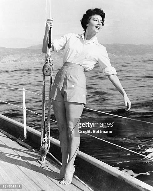 San Remo, Italy: Hanging onto the boat's rigging, actress Ava Gardner enjoys a breezy outing in the Riviera sunshine. Glamourous Ava is in Italy for...