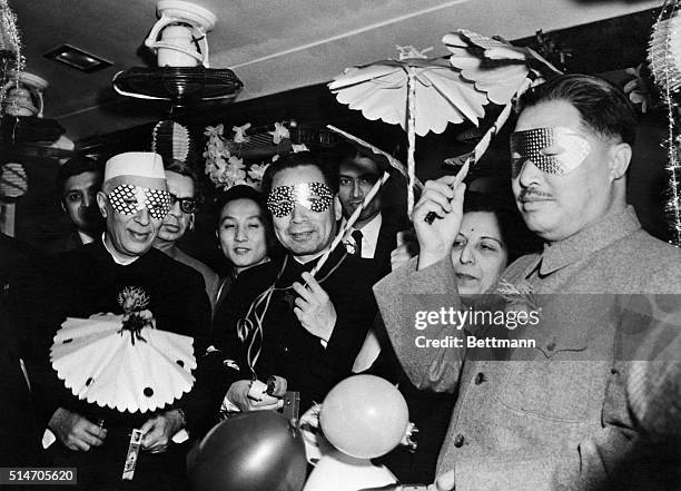 Delhi, India: Behind the festive New Year masks are Indian Premier Jawaharlal Nehru, Communist Chinese Premier Chou En-Lai and Vice Premier Ho Lung....