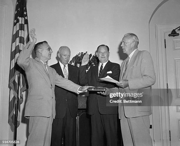 Washington, DC: President Eisenhower presents Commissions of Office to Dr. T. Keith Glennan, of Cleveland administrator of the new National...