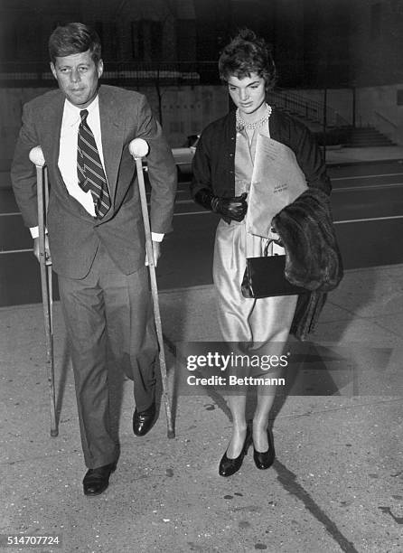 New York: Senator John F. Kennedy, Massachusetts Democrat, hobbles on crutches into the hospital for special surgery in New York to undergo an...