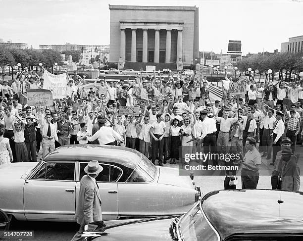 Baltimore, MD: Police restrain some 2,000 white teenagers, bearing slogans against racial integration who marched on City Hall and shouted in vain...