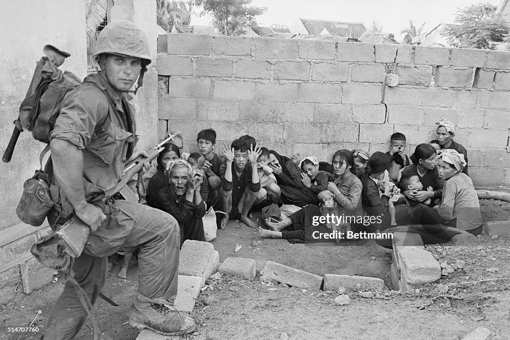 Soldier Guarding Civilians