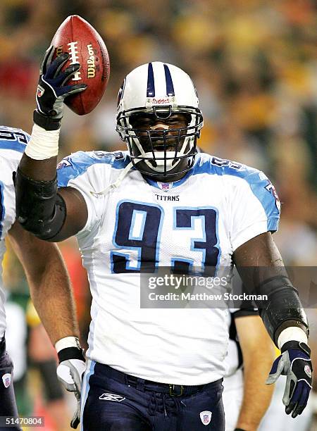 Kevin Carter of the Tennessee Titans recovers a fumble against the Green Bay Packers during the first quarter October 11, 2004 at Lambeau Field in...