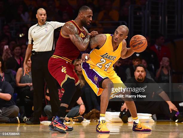 Kobe Bryant of the Los Angeles Lakers backs in on LeBron James of the Cleveland Cavaliers during the first half at Staples Center on March 10, 2016...