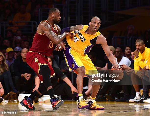 Kobe Bryant of the Los Angeles Lakers backs in on LeBron James of the Cleveland Cavaliers during the first half at Staples Center on March 10, 2016...