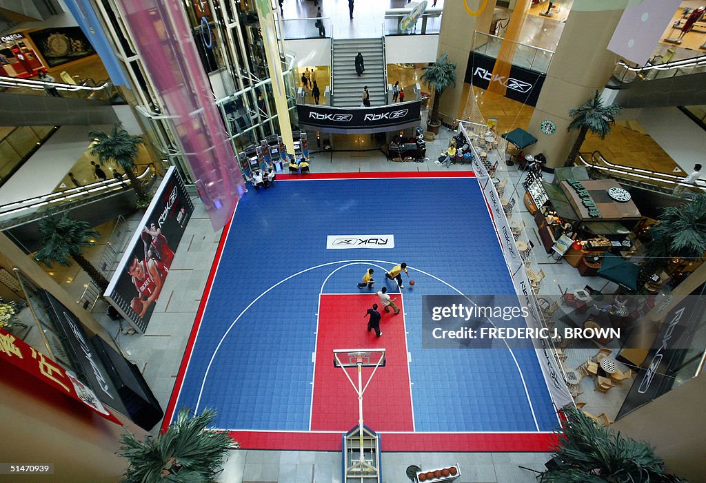 Kids play basketball on a court set up i