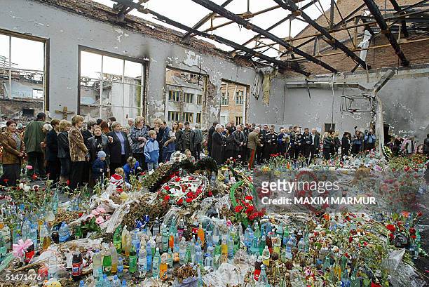 Ossetians mourn at the destroyed school's gymnasium in Beslan 12 October 2004. This week marks the end of the traditional 40 day mourning period...