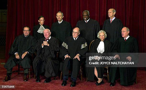 This 05 December, 2003 shows the justices of the Supreme Court of the United States posing for an official photo at the Supreme Court in Washigton...