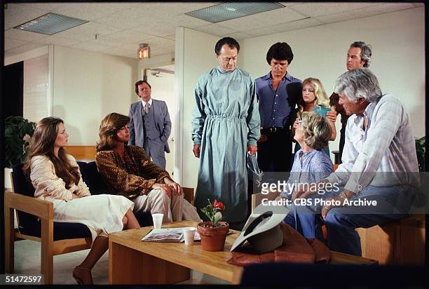 In a scene from the American television series 'Dallas,' cast member gather in a hospital to hear the fate of recently shot character J.R. Ewing in...
