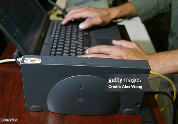 Broadband Over Power Line modem is sits next to a laptop during a tour to view the technologies October 12, 2004 in Manassas, Virginia. BPL...