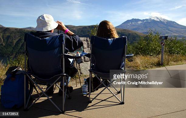 Roger and Judy Bell from Salem, Oregon watch as Mount St. Helens erupts with steam October 12, 2004 in Washington. The steam eruptions have increased...