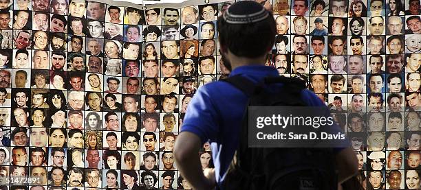 Graduate student Jonas Rosenbloom 27, looks at faces of Israelis killed by suicide bombings on display at Duke University on October 12, 2004 in...