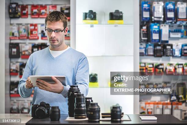 man holding digital tablet in the store - mini grocery store stock pictures, royalty-free photos & images