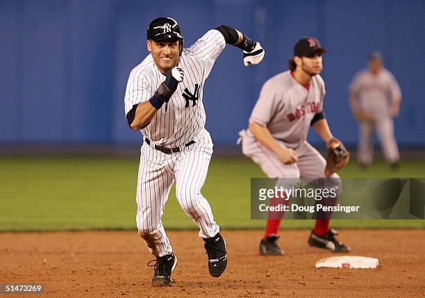 Derek Jeter of the New York Yankees runs to third base before scoring on a three-run double by Hideki Matsui against the Boston Red Sox in the third...