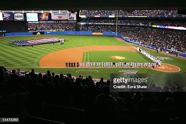 The New York Yankees and Boston Red Sox line up for the National Anthem before game one of the American League Championship Series on October 12,...