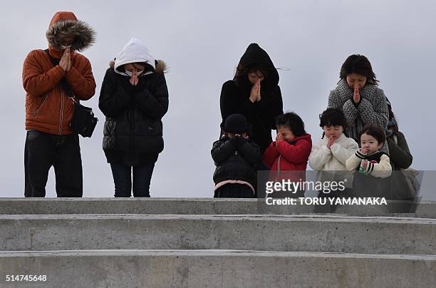 People pray for victims of the 2011 earthquake and tsunami in Sendai, northern Japan on March 11, 2016. Japan on March 11 marked the fifth...