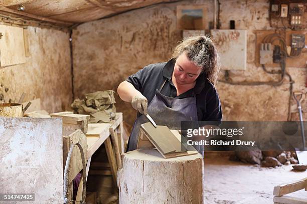 female brickmaker making hand-thrown tile - dedication brick stock pictures, royalty-free photos & images