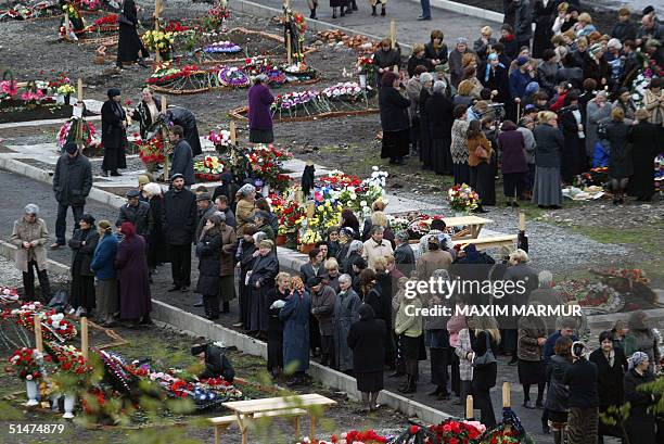 Relatives and friends of victims of the Beslan school siege mourn, 13 October 2004 at the cemetery in the north Ossetian town. This week marks the...