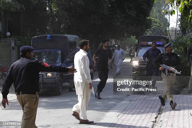 Pakistani police guards stand outside the house of Shahbaz Taseer - son of slain governor of Pakistan's Punjab province Salman Taseer, arrives at his...