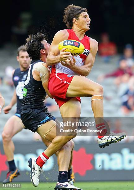 Kurt Tippett of the Swans marks infront of Michael Jamison of the Blues during the NAB Challenge AFL match between the Carlton Blues and the Sydney...