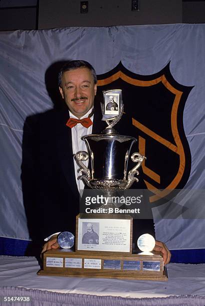 Canadian ice hockey coach Jacques Demers poses with his second straight Jack Adams Trophy, a 'coach of the year' trophy awarded by the National...