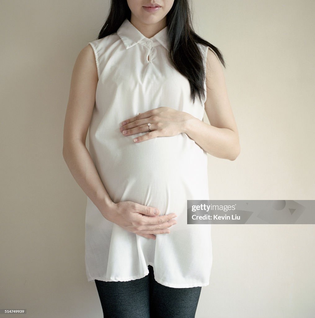 Pregnant woman touching her belly