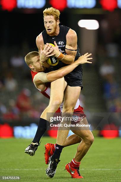 Daniel Gorringe of the Blues collects Daniel Hannebery of the Swans as he marks during the NAB Challenge AFL match between the Carlton Blues and the...