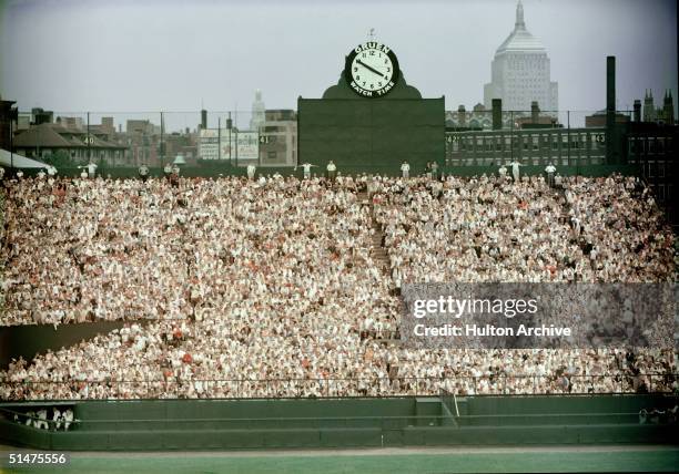 General view of Boston's Fenway Park, home of the American League baseball team the Boston Red Sox shows the fans packed in the bleachers in the...