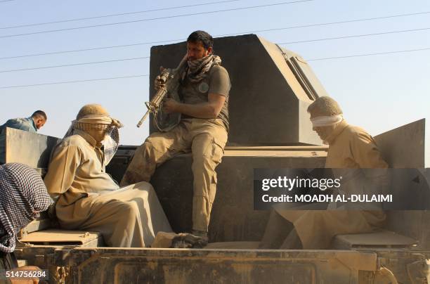 Iraqi government and counter-terrorism forces arrest men suspected of belonging to the Islamic State jihadist group on March 10, 2016 following an...