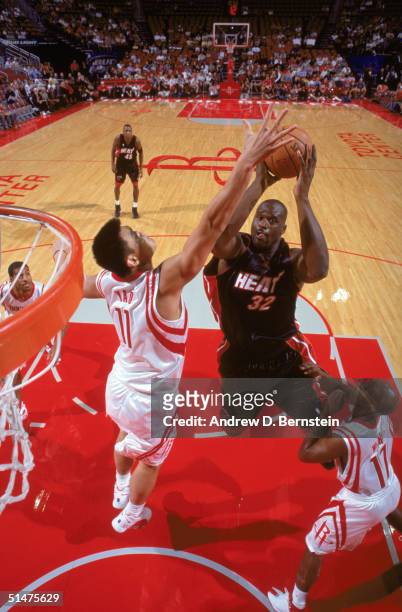 Shaquille O'Neal of the Miami Heat puts a shot up against Yao Ming of the Houston Rockets during the NBA Preseason game at Toyota Center on October...