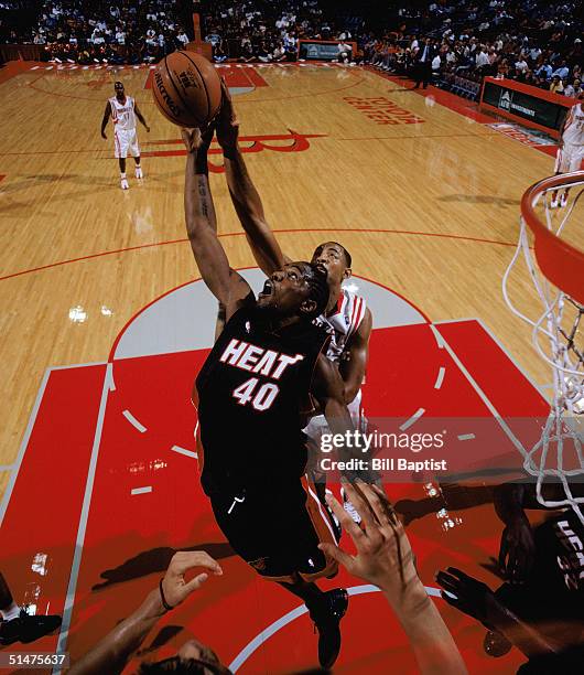 Udonis Haslem of the Miami Heat reaches for the ball against Juwan Howard of the Houston Rockets during a NBA Preseason game at Toyota Center on...