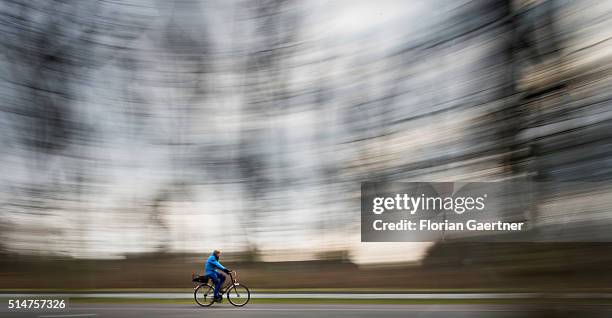 Man rides with his bicycle through Treptower Park on March 07, 2016 in Berlin, Germany.