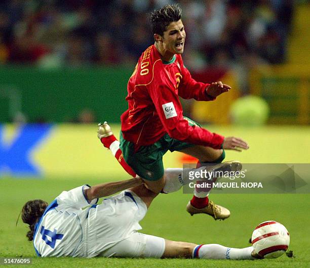 Portugal's player Cristiano Ronaldo is tackled by Russia's Alexey Smertin during the World Cup 2006 qualifying football match, at Alvalade Stadium in...